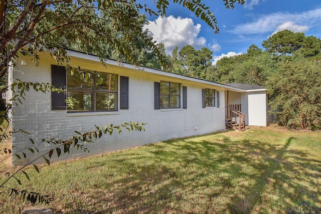 view of side of property featuring a yard