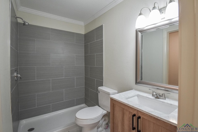 bathroom featuring a tile shower, crown molding, vanity, and toilet