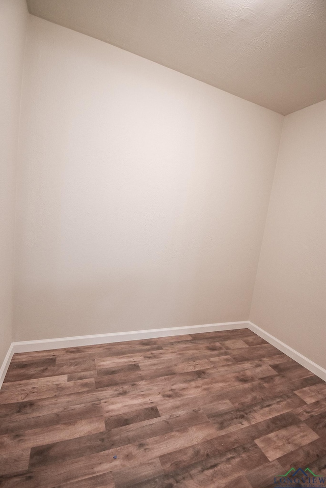 spare room with dark hardwood / wood-style flooring