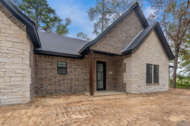 rear view of property featuring a patio area