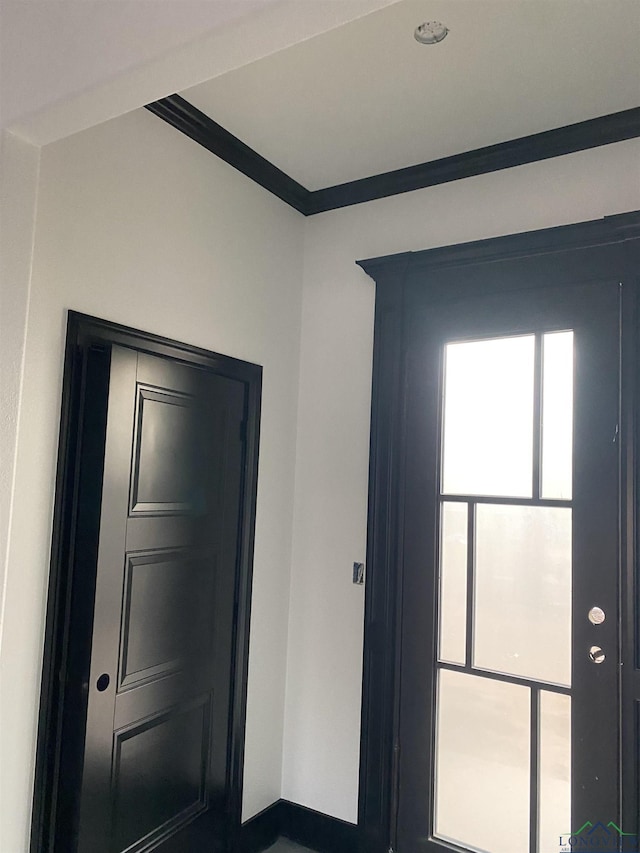 interior space with crown molding