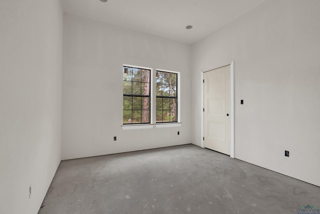 unfurnished room featuring concrete floors