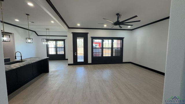 interior space featuring a wealth of natural light, crown molding, sink, and light hardwood / wood-style flooring