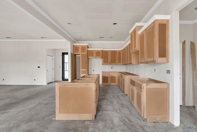 kitchen featuring light brown cabinetry, a kitchen island, and ornamental molding