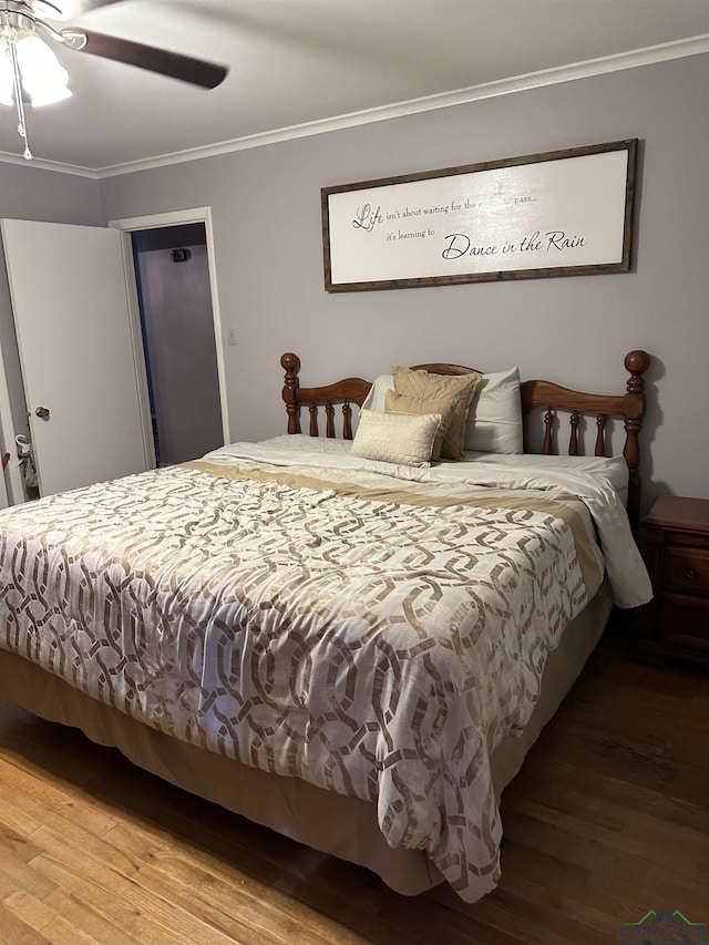 bedroom featuring ceiling fan, hardwood / wood-style flooring, and ornamental molding