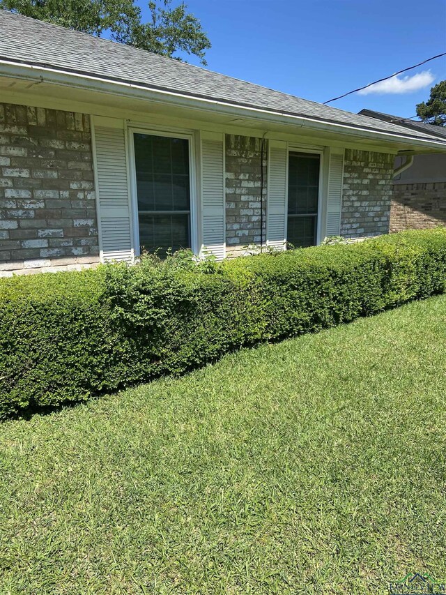 509 Pinewood Dr, Marshall, TX 75672 - entrance to property featuring brick siding, a yard, and a shingled roof