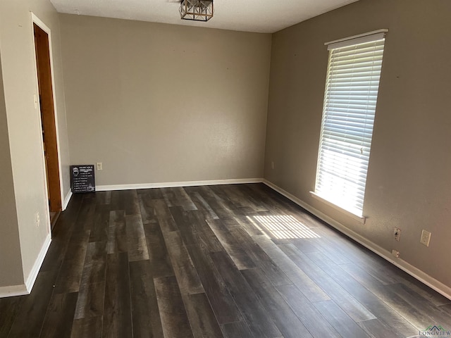 509 Pinewood Dr, Marshall, TX 75672 - empty room with dark wood-style floors and baseboards