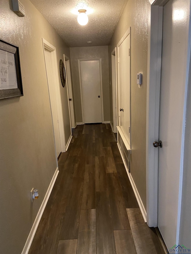 509 Pinewood Dr, Marshall, TX 75672 - hallway with a textured ceiling, wood finished floors, and a textured wall