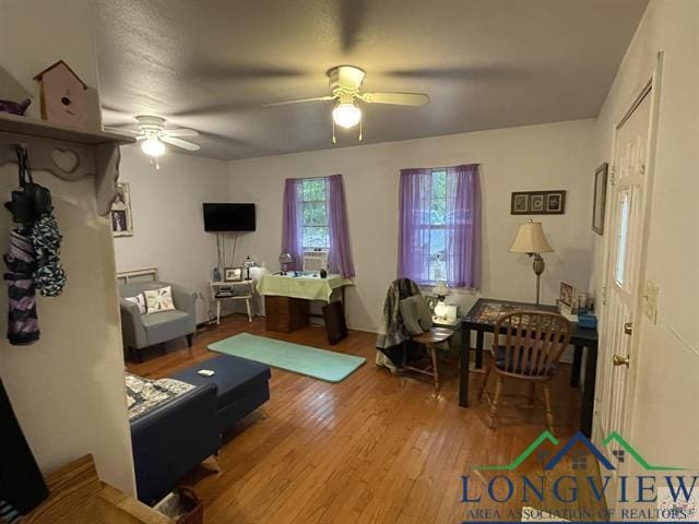 living room with ceiling fan and light hardwood / wood-style floors