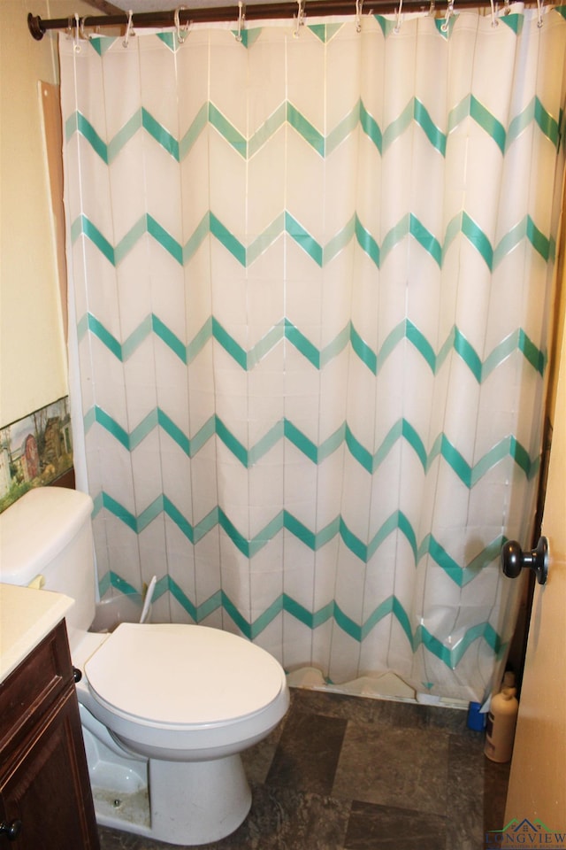 bathroom featuring toilet, curtained shower, and vanity