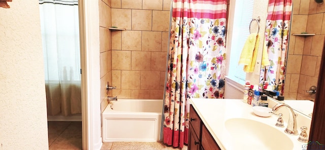 full bathroom with tile patterned floors, shower / tub combo with curtain, and vanity