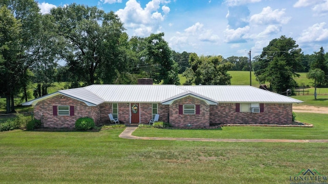 1226 County Road 1896, Linden, TX 75563 - single story home with a front lawn, a metal roof, and a chimney