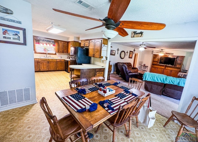 1226 County Road 1896, Linden, TX 75563 - dining area with ceiling fan, a textured ceiling, and light colored carpet