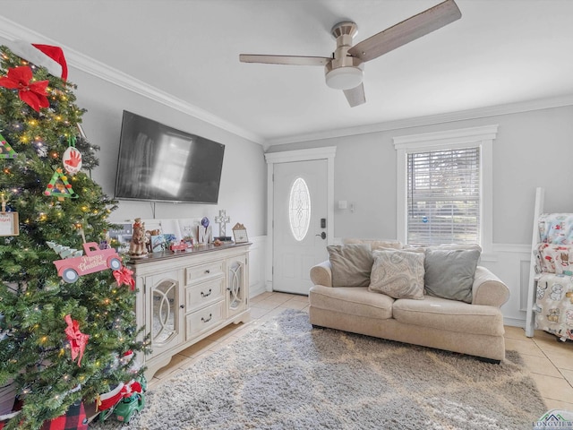 living room featuring ceiling fan, ornamental molding, and light tile patterned flooring