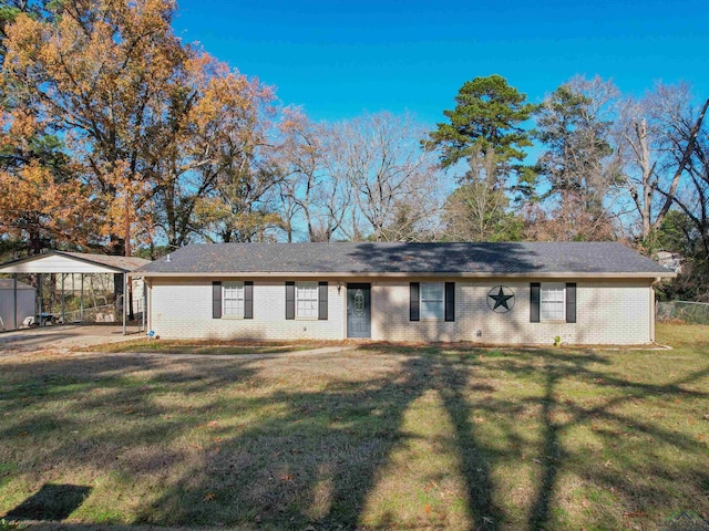 single story home with a front yard and a carport