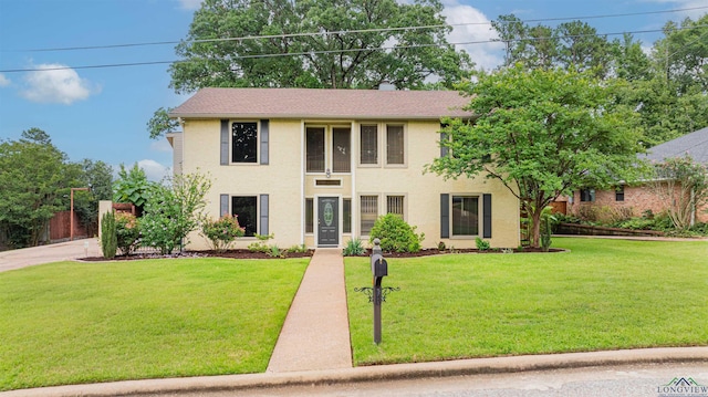 1822 Northwood Ct, Longview, TX 75604 - colonial home with a front lawn, stucco siding, and a chimney