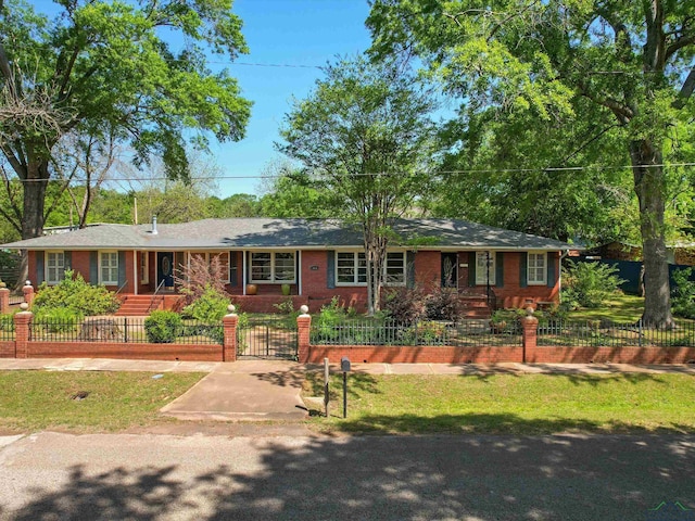 single story home with brick siding and a fenced front yard