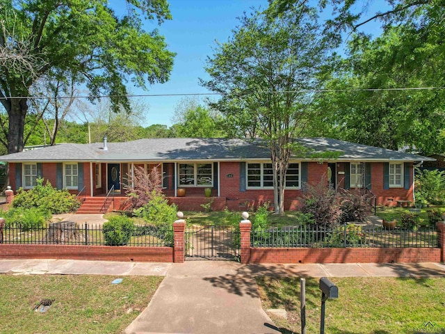 single story home with brick siding, a gate, and a fenced front yard