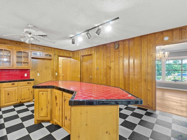 kitchen featuring tile patterned floors, track lighting, and tile countertops