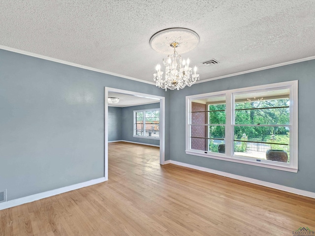 unfurnished dining area with baseboards, wood finished floors, a chandelier, and crown molding