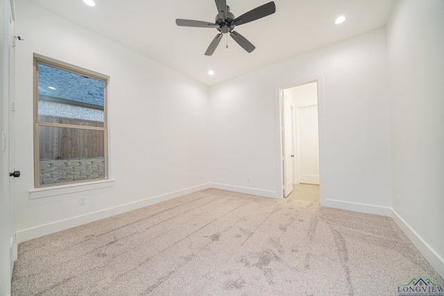 carpeted empty room featuring ceiling fan