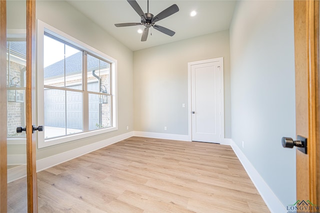 unfurnished room with ceiling fan and light wood-type flooring