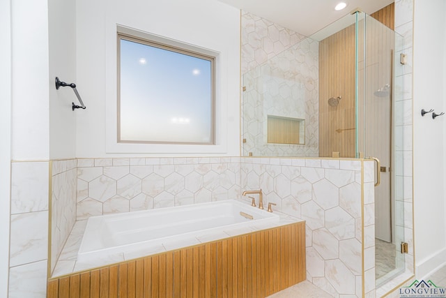 bathroom featuring separate shower and tub