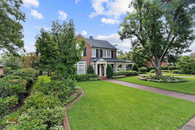 colonial-style house with a front lawn