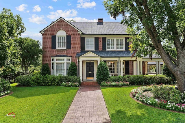 colonial-style house with a front lawn