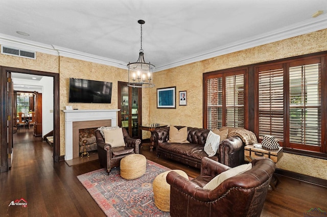 living room featuring dark hardwood / wood-style floors, a wealth of natural light, ornamental molding, and a notable chandelier