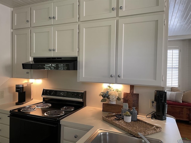 kitchen featuring white cabinetry, extractor fan, and black range with electric cooktop