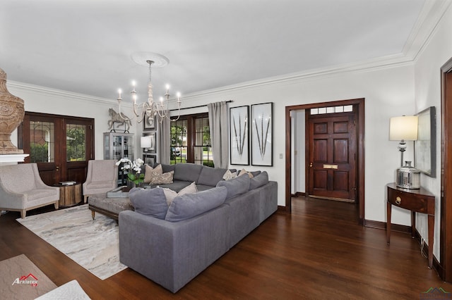 living room featuring dark hardwood / wood-style floors, an inviting chandelier, and crown molding