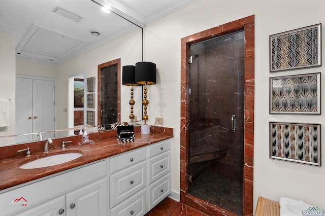 bathroom with vanity, a shower with shower door, and ornamental molding