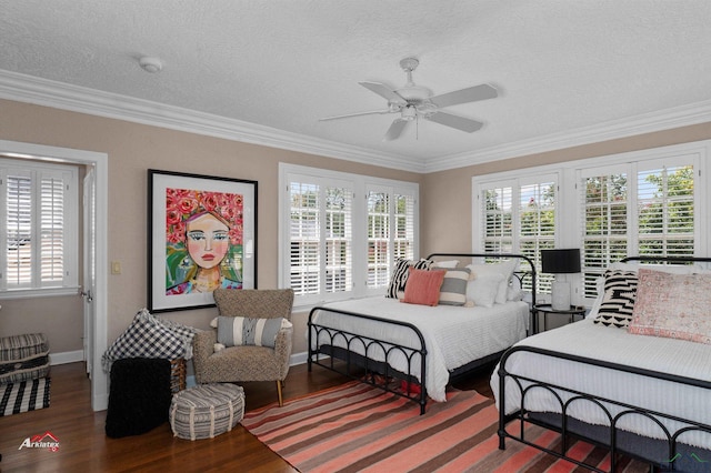 bedroom with multiple windows, ceiling fan, crown molding, and hardwood / wood-style flooring