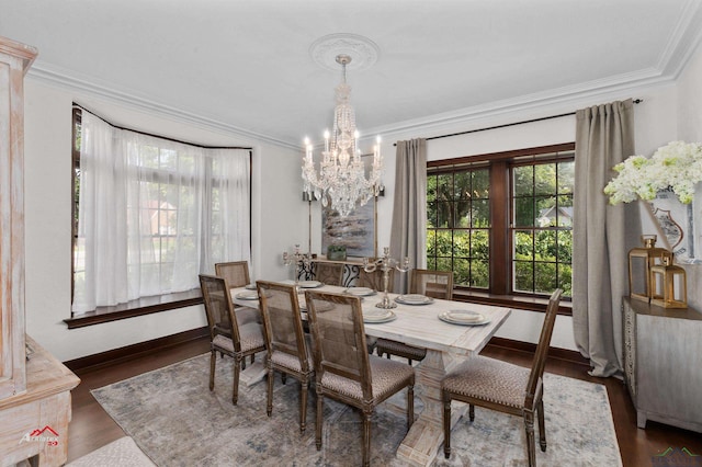 dining space featuring dark hardwood / wood-style flooring, ornamental molding, and an inviting chandelier