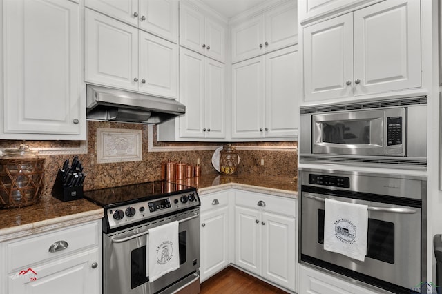 kitchen with white cabinets, decorative backsplash, and stainless steel appliances