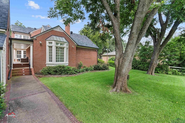 view of property exterior with a yard