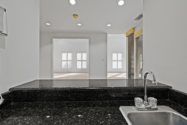 kitchen with sink and dark stone counters