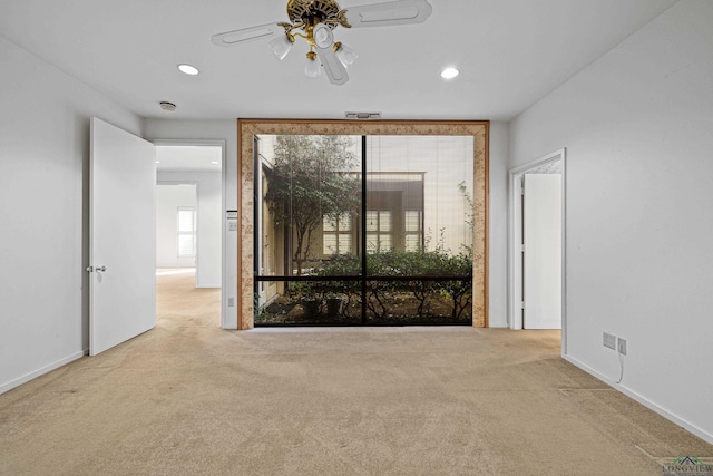 spare room with light carpet and ceiling fan