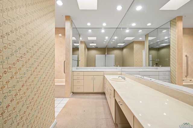 bathroom featuring a skylight, tile patterned flooring, and vanity