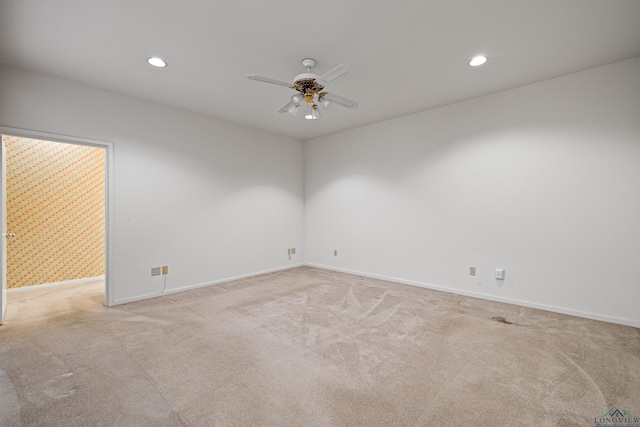 carpeted spare room with ceiling fan