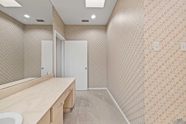 bathroom with vanity and a skylight