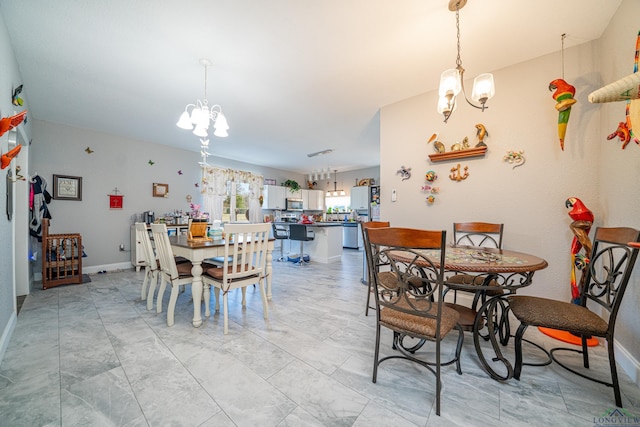 dining room featuring baseboards and a chandelier