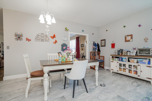 dining space with an inviting chandelier, baseboards, and marble finish floor