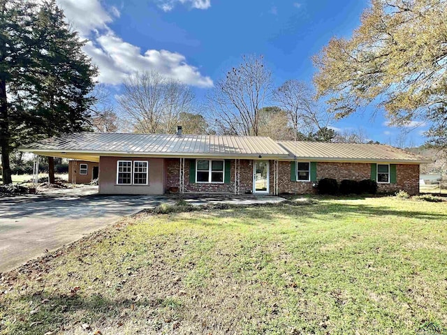 ranch-style home featuring a front yard and a carport