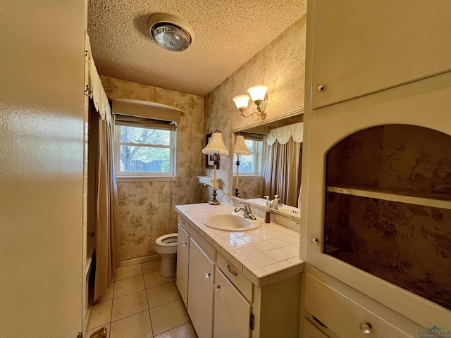 full bathroom featuring tile patterned floors, bathtub / shower combination, a textured ceiling, vanity, and toilet