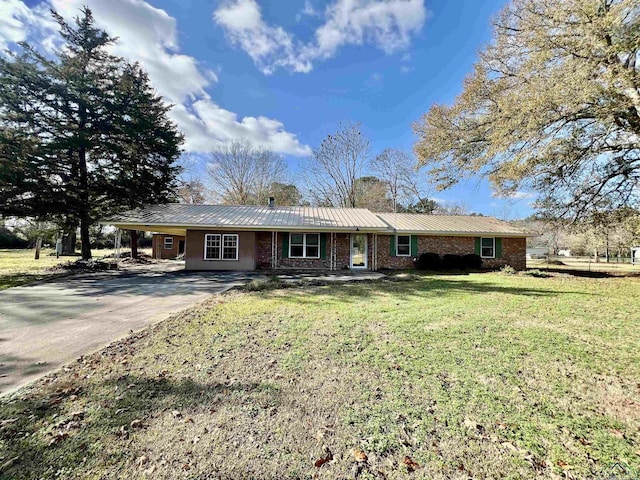 ranch-style house featuring a carport and a front lawn