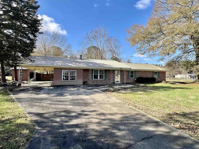 single story home with a front yard and a carport