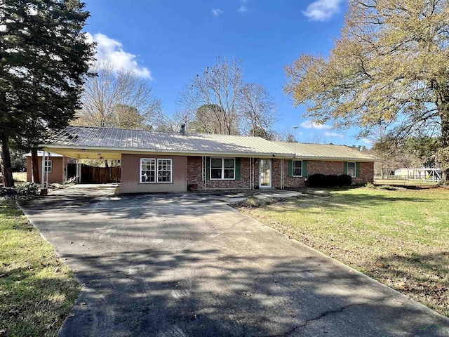 1400 Shreveport St, Elysian Fields, TX 75642 - single story home featuring driveway, a front lawn, a metal roof, and an attached carport