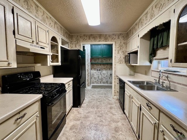 kitchen featuring black appliances, crown molding, sink, and a textured ceiling